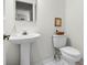 Simple bathroom with pedestal sink and toilet at 27039 Racquet Cir, Leesburg, FL 34748