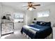 Bedroom with a queen bed, and a view of the backyard at 27039 Racquet Cir, Leesburg, FL 34748