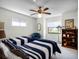Cozy bedroom with twin beds, a sitting chair, and built-in shelving at 27039 Racquet Cir, Leesburg, FL 34748