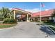 Inviting community center entrance with covered drive at 27039 Racquet Cir, Leesburg, FL 34748