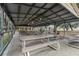 Covered picnic pavilion with tables and benches, ceiling fans, and lighting at 27039 Racquet Cir, Leesburg, FL 34748