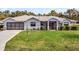 One-story home with gray exterior, screened porch, and landscaped lawn at 27039 Racquet Cir, Leesburg, FL 34748