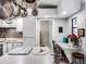 Kitchen with an island, white cabinets and a view into another room at 27039 Racquet Cir, Leesburg, FL 34748