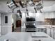 Kitchen with stainless steel appliances and a pot rack at 27039 Racquet Cir, Leesburg, FL 34748