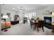 Open living space with fireplace, dining area, and access to a lanai at 27039 Racquet Cir, Leesburg, FL 34748
