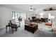 Open living room with fireplace, seating area, and sunroom access at 27039 Racquet Cir, Leesburg, FL 34748