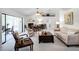 Spacious living area featuring a dining space and access to a sunroom at 27039 Racquet Cir, Leesburg, FL 34748
