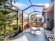 Peaceful screened porch with comfortable seating and lush landscaping at 27039 Racquet Cir, Leesburg, FL 34748