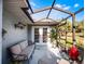 Spacious screened patio with comfortable seating and access to backyard at 27039 Racquet Cir, Leesburg, FL 34748