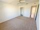 Bedroom features neutral carpet, white trim and walls, and a closet for storage at 2707 Privada Dr, The Villages, FL 32162