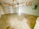 The spacious garage has an open garage door to let fresh air in on a sunny day at 2707 Privada Dr, The Villages, FL 32162