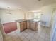 View of the kitchen island with cabinets and drawers, situated between the kitchen and living room at 2707 Privada Dr, The Villages, FL 32162