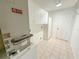 Laundry room features white cabinets, a Trane HVAC, tile floor, and a utility door at 2707 Privada Dr, The Villages, FL 32162