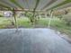 Covered patio area overlooking the yard at 29 Lonesome Pine Trl, Yalaha, FL 34797