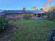 Brick home with solar panels and a covered patio at 29 Lonesome Pine Trl, Yalaha, FL 34797