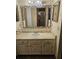 Clean bathroom with vanity and large mirror at 29 Lonesome Pine Trl, Yalaha, FL 34797