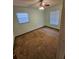 Bedroom with two windows and ceiling fan at 29 Lonesome Pine Trl, Yalaha, FL 34797