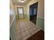 Bright entryway with light green walls and tiled flooring at 29 Lonesome Pine Trl, Yalaha, FL 34797