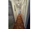 Long hallway with tile flooring and built-in storage at 29 Lonesome Pine Trl, Yalaha, FL 34797