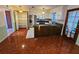 Eat-in kitchen with wood-look flooring and ample cabinet space at 29 Lonesome Pine Trl, Yalaha, FL 34797