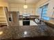 Kitchen features stainless steel appliances and granite countertops at 29 Lonesome Pine Trl, Yalaha, FL 34797