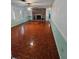 Large living room features wood-look floors and brick fireplace at 29 Lonesome Pine Trl, Yalaha, FL 34797