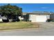 Single story home with attached garage and well-manicured lawn at 32728 Timberwood Dr, Leesburg, FL 34748