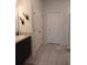 Bright bathroom featuring a granite-top vanity with a sink and storage, a shower, and closet at 37030 Lake Overlook Dr, Grand Island, FL 32735