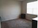 Bedroom featuring neutral carpet, one window and dark furniture at 37030 Lake Overlook Dr, Grand Island, FL 32735