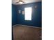 Bedroom with bright blue walls and carpeting, lit by a window and ceiling fan at 37030 Lake Overlook Dr, Grand Island, FL 32735