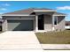 One-story house with a two-car garage and a well-manicured lawn at 37030 Lake Overlook Dr, Grand Island, FL 32735