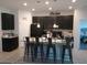 Bright kitchen featuring a central island with barstools and black appliances and cabinetry at 37030 Lake Overlook Dr, Grand Island, FL 32735