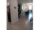 Open-concept kitchen featuring dark cabinets, an island with barstool seating, stainless steel appliances, and tile flooring at 37030 Lake Overlook Dr, Grand Island, FL 32735