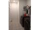 Clean laundry room featuring gray walls, shelving, and modern black washer and dryer at 37030 Lake Overlook Dr, Grand Island, FL 32735