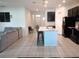 Spacious living room with tile flooring, an open-concept kitchen, and neutral decor, creating a welcoming atmosphere at 37030 Lake Overlook Dr, Grand Island, FL 32735