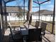 Spacious screened patio with table and chairs, ideal for outdoor entertaining at 37030 Lake Overlook Dr, Grand Island, FL 32735