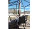 Relaxing screened patio with table and chairs, perfect for outdoor dining at 37030 Lake Overlook Dr, Grand Island, FL 32735