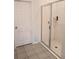 Modern walk-in shower with glass door, tile surround, and convenient built-in shelving at 37030 Lake Overlook Dr, Grand Island, FL 32735