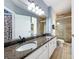 Bathroom with double vanity, granite countertops, and a walk-in shower at 413 Summit Ridge Pl # 201, Longwood, FL 32779