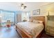 Bright main bedroom featuring a king bed and sitting area at 413 Summit Ridge Pl # 201, Longwood, FL 32779