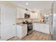 Modern kitchen with stainless steel appliances and white cabinets at 4429 Homan Loop, The Villages, FL 32163