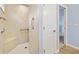 Walk-in shower with a built-in seat and grab bar at 4429 Homan Loop, The Villages, FL 32163