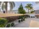 Landscaped backyard with a paved patio and privacy wall at 446 Flossmoor Ct, The Villages, FL 32162