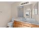 Bathroom with wood vanity, quartz countertop and toilet at 446 Flossmoor Ct, The Villages, FL 32162