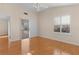 Bedroom with wood floors, sliding door to sunroom, and plantation shutters at 446 Flossmoor Ct, The Villages, FL 32162