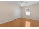 Simple bedroom with hardwood floors, ceiling fan, and double door closet at 446 Flossmoor Ct, The Villages, FL 32162