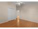 Light-filled bedroom with wood floors and double door closet at 446 Flossmoor Ct, The Villages, FL 32162