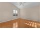 Bright bedroom with hardwood floors and large window at 446 Flossmoor Ct, The Villages, FL 32162