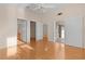 Hardwood floor bedroom with access to bathroom and patio at 446 Flossmoor Ct, The Villages, FL 32162