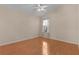 Bright bedroom featuring wood floors and a window with curtains at 446 Flossmoor Ct, The Villages, FL 32162